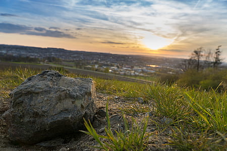 Gray Stone on Grassy Field during Under Cloudy Sky during Sunset thumbnail