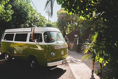 green and white Volkswagen van parked in front of building thumbnail