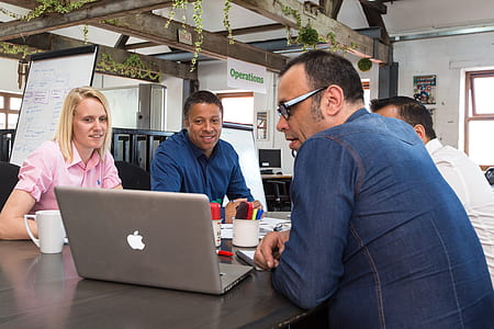 group of people looking at MacBook Pro thumbnail