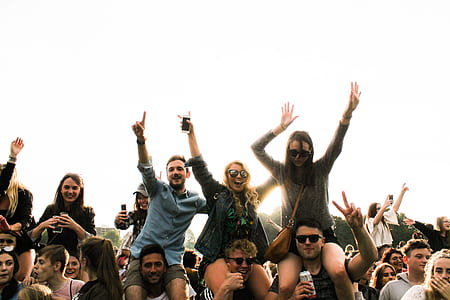 people at a party with beers raising their hands during daytime thumbnail