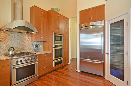 silver gas range oven and brown wooden kitchen cabinets thumbnail