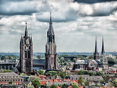 black and brown concrete cathedral under cloudy sky thumbnail