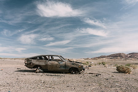 brown car on desert during daytime thumbnail