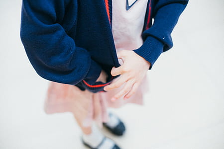 closeup photo of person holding her blue jacket thumbnail