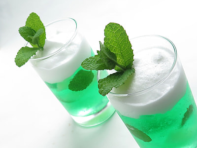 two green drinks in clear glass containers thumbnail