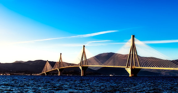 brown concrete bride across the sea under blue sky during daytime thumbnail