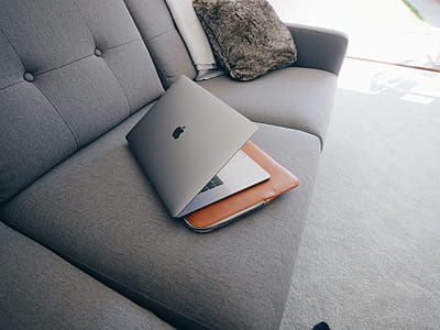 silver MacBook Pro on top of the sofa thumbnail