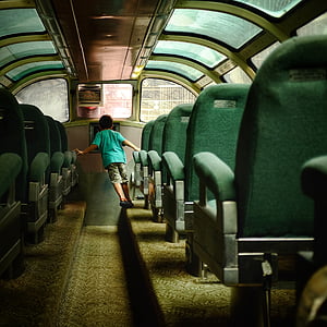 boy wearing teal shirt at bus isle thumbnail