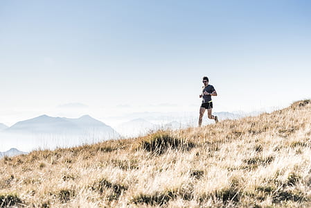 person running on grass during daytime thumbnail