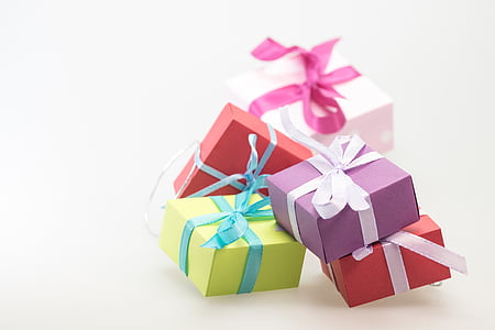 shallow focus photography of four assorted-color gift boxes thumbnail