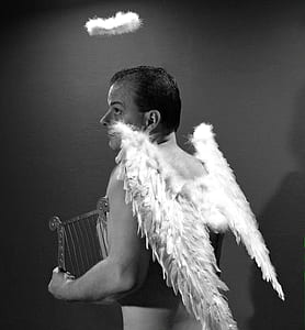 grayscale photography of man with angel wings thumbnail