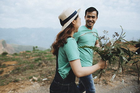 woman holding white and green flowers thumbnail