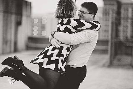 grayscale photography of man embracing woman thumbnail