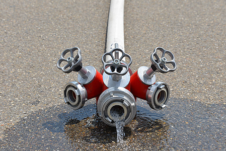 white and red water hose on gray concrete pavement thumbnail