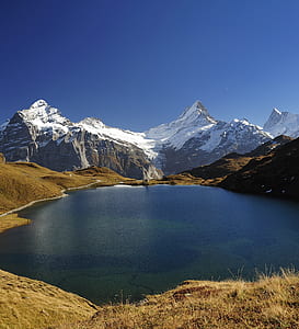 mountain alps near water thumbnail