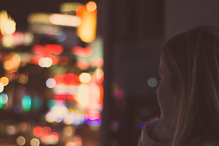 woman in white top in city light bokeh thumbnail