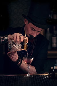 man pouring liquor on glass thumbnail