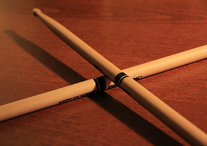 pair of brown drumsticks on wooden table thumbnail