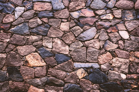 person taking photo of assorted-color rocks thumbnail