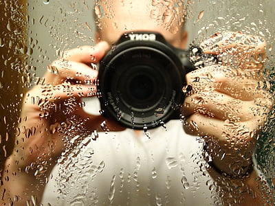 shallow focus photography of person in front of mirror thumbnail