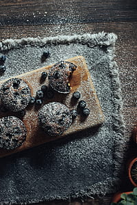 chocolate cookies with white powder on brown board thumbnail