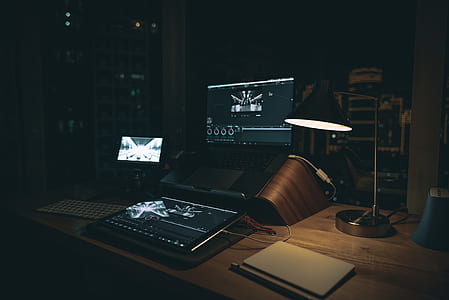 black and gray laptop computer turned on on table thumbnail