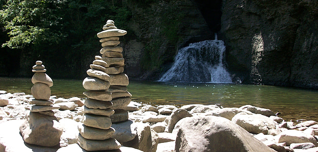 rock formation near water falls during daytime thumbnail