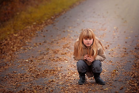 photo of woman sitting on road thumbnail