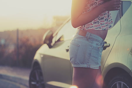 woman standing beside a car thumbnail
