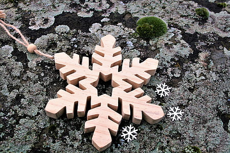 brown wooden snowflakes-themed hanging decor on gray surface thumbnail