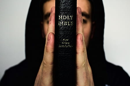 person holding Holy Bible thumbnail