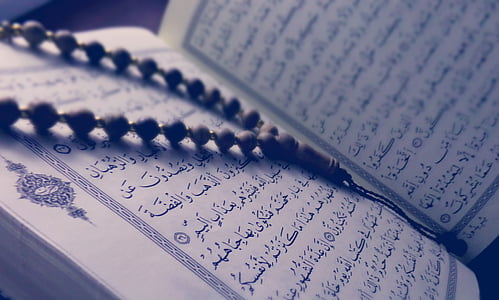 black prayer beads on top of open book thumbnail