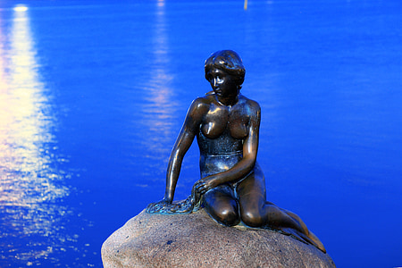 woman statue on top of stone thumbnail