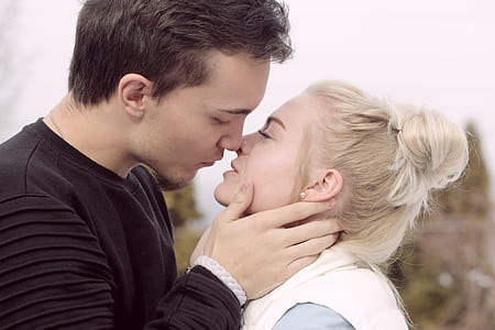 man wearing black top about to kiss woman thumbnail