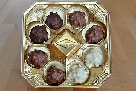 white and brown chocolates in gold tray thumbnail