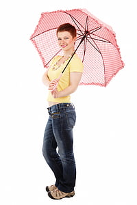 smiling woman wearing yellow blouse and blue denim jeans holding pink umbrella thumbnail