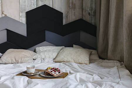 Breakfast in bed - waffles with raspberries and cup of coffee on the tray thumbnail