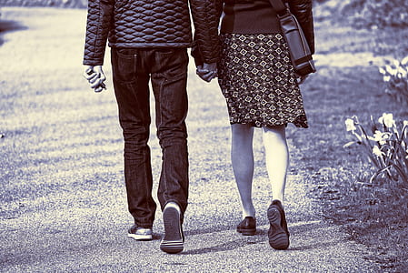 man and woman holding hands white walking thumbnail