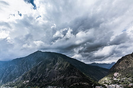 mountains under cloudy sky at dayitme thumbnail