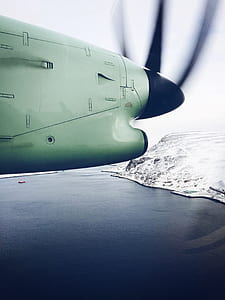 beige and black plane speeding above body of water at daytime thumbnail
