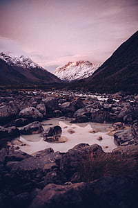 body of water and rocks thumbnail