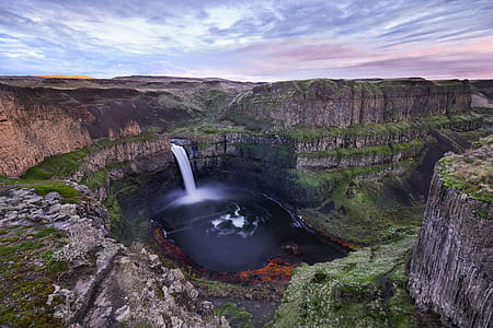 time lapse photography of waterfall surrounded by gray rocky mountains thumbnail