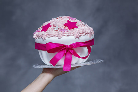person holding fondant cake with star toppings thumbnail