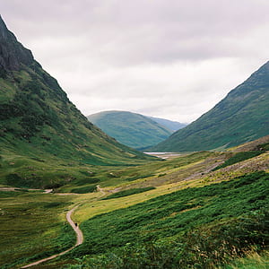 aerial view photography of road in between two mountains thumbnail