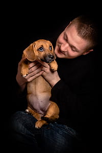 man holding brown puppy thumbnail