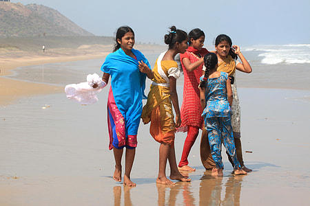 five girls standing at seashore thumbnail