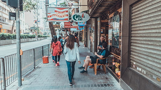people walks on sidewalk with railings at daytime thumbnail