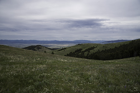 Overlapping hill landscape with mountains in the background in Helena thumbnail