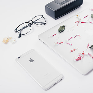 silver iPhone 6 and black framed eyeglasses thumbnail