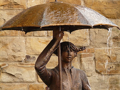 man holding umbrella statuette thumbnail